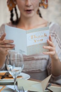 woman holding white happy birthday greeting card