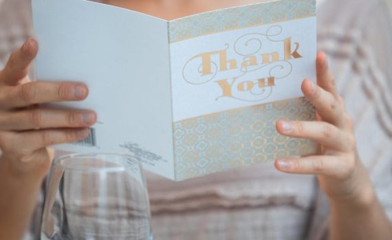 woman holding white happy birthday greeting card