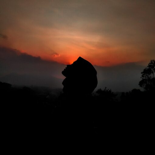 silhouette of person against sunset sky