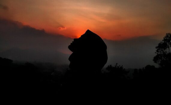 silhouette of person against sunset sky