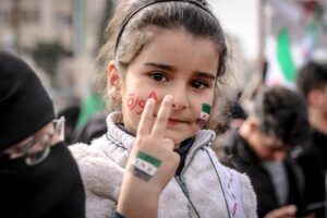 close up photo of young girl doing peace sign