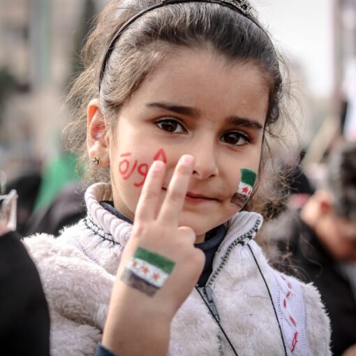 close up photo of young girl doing peace sign