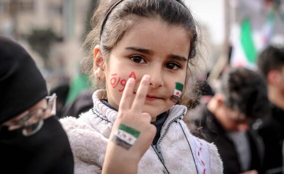 close up photo of young girl doing peace sign