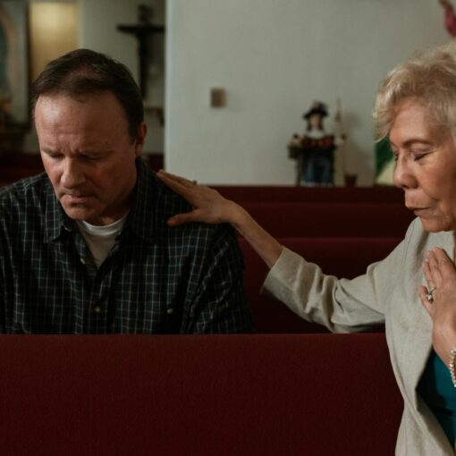 a man and a woman praying inside the church