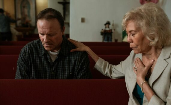 a man and a woman praying inside the church