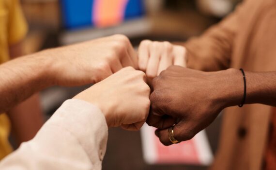 group of people with their fists together