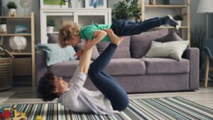 woman lying down and playing with son
