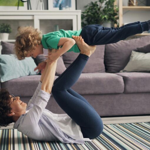 woman lying down and playing with son