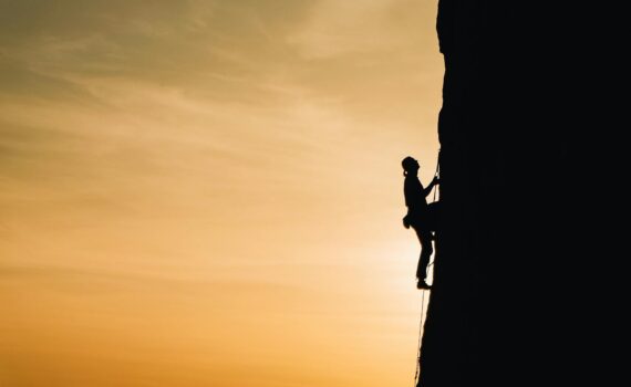 person rock climbing
