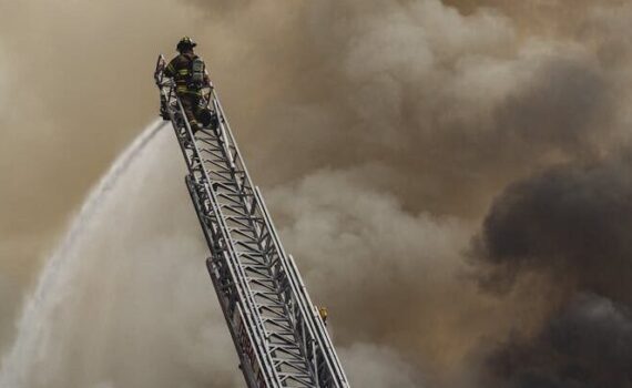 fireman on top of a ladder
